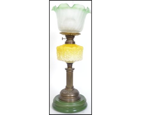 Late 19th Century brass double burner oil lamp with repousse yellow on milk glass glass reservoir on pierced metal pedestal c