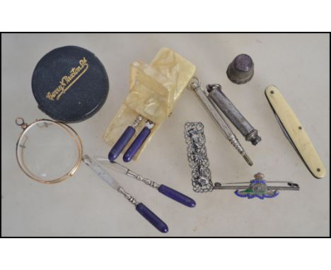 A vintage silver S Mordan & Co propelling pencil together with a white metal propelling pencil, a silver and enamel military 