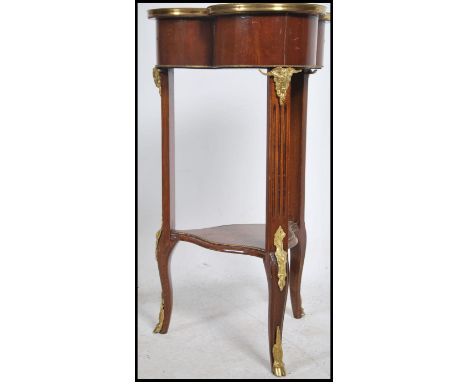 A stunning marquetry and gilt metal mounted lamp / hall table in the manner of Napoleon III. The table with clover shaped top
