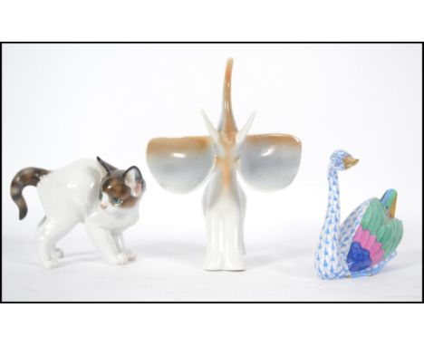 A Rosethall German ceramic cat along with a Hollohaza Hungarian Elephant figurine and a Herend Hungary hand painted swan. Tal