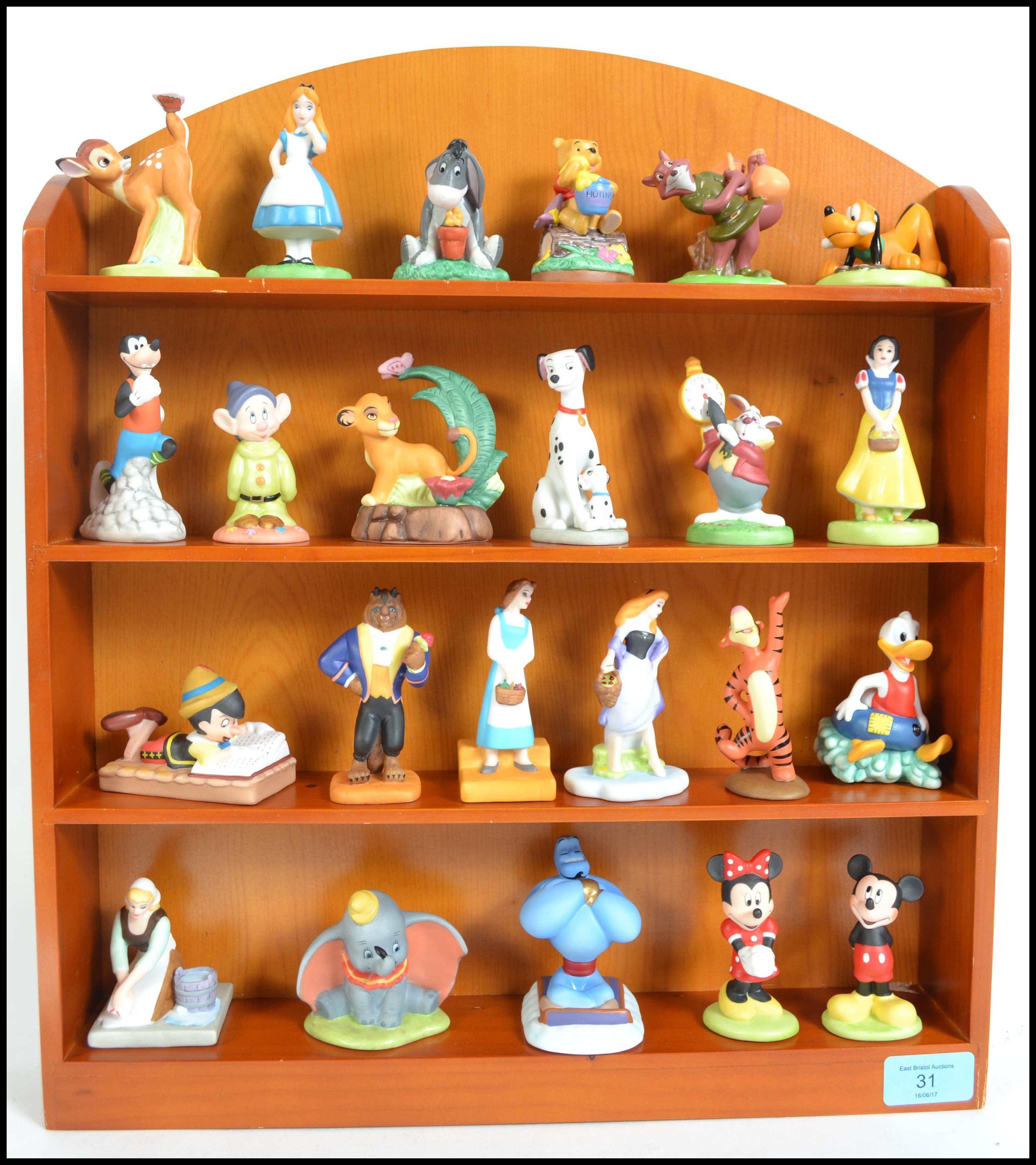 A collection of 23 Walt Disney ceramic characters to include Micky and