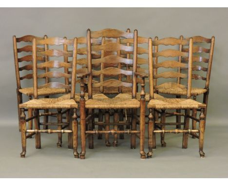 A set of eight early 19th century style elm ladder back chairs, including a pair of elbow chairs