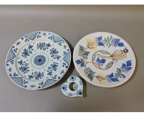 A Delft blue and white charger, restored, 33.5cm diameter, a heart shaped inkwell, 11cm, and a polychrome charger, painted wi