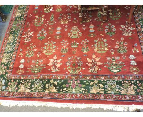 A burgundy ground carpet, in the Persian style, 430 x 300cm