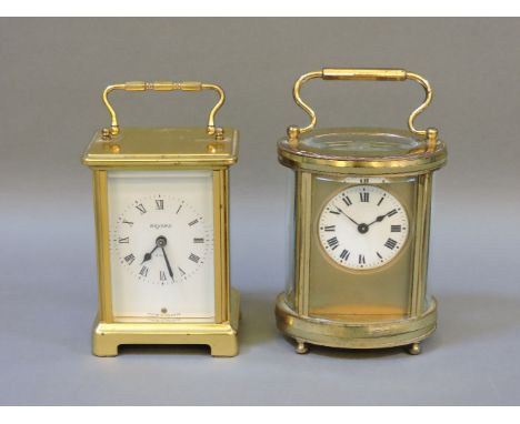 An oval cased carriage clock, and another