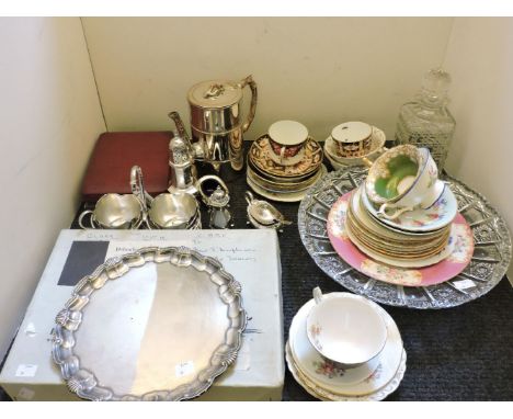 A collection of mixed silver plate, ceramics, place mats, a decanter, and a bowl