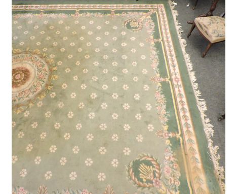 A large Aubusson style green carpet