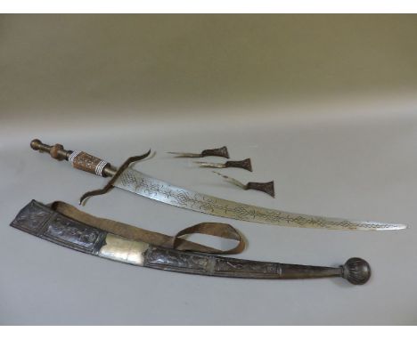 A Tuareg sword, from Niger, the engraved blade in a metal mounted tooled leather scabbard, 104cm long overall