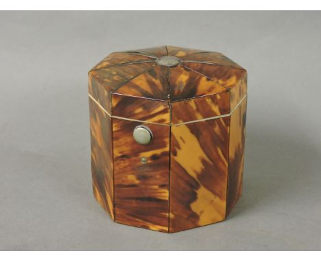 A tortoiseshell octagonal tea caddy, with a silver button top and an internal cover, marbled paper to the underside, 95cm