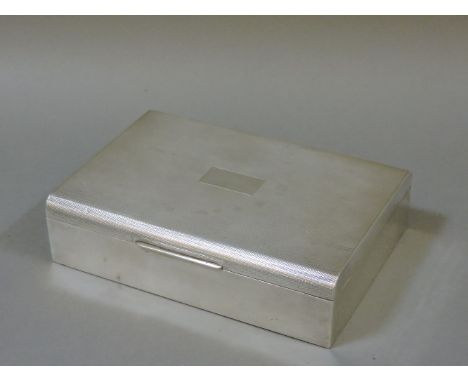 A silver table top cigarette box, Birmingham 1966, with an engine turned cover, 17cm wide