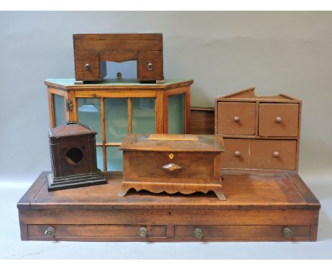 A mahogany shotgun case, an oak/mahogany jewellery box, a mahogany sewing box in the form of a desk, a pine glazed wall cabin