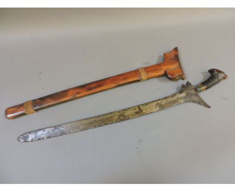 An Indonesian kris sword, with curved blade, in  a wooden sheath, 69cm long and a Japanese wooden and steel hook stick, signe