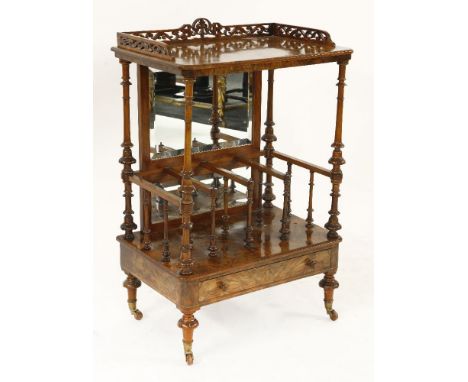 A Victorian strung walnut whatnot, with a fret cut 3/4 gallery over a shelf, on turned supports, a rear mirror, four compartm