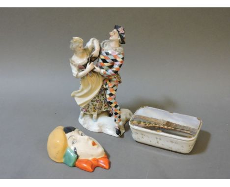 A Sitzendorf harlequin and lady dancing, 15.5cm high, a pot and cover, underglaze SPM mark, and a Czechoslovakian wall mask