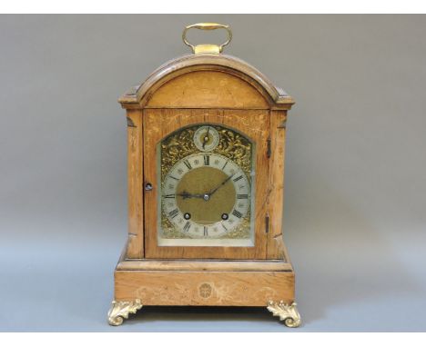 A German inlaid walnut mantel clock, striking on two gongs and raised on ormolu feet, 41cm high