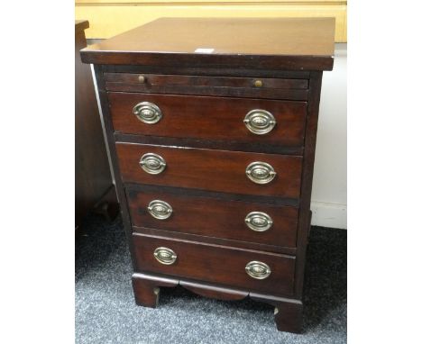 REPRODUCTION HARDWOOD SMALL CHEST having four drawers, brass handles, bracket feet and a slide drawer, 48cms wide