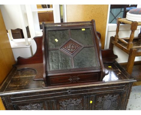 VINTAGE CONTINENTAL MAHOGANY HANGING CORNER WALL CUPBOARD with four section green glass door, centre cartouche with carved in