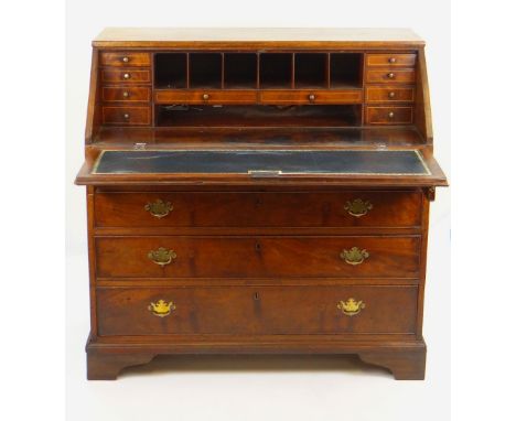 GEORGIAN MAHOGANY BUREAU four long drawers, sloped front hinging to reveal inlaid drawers, pigeon holes and tooled leather wr
