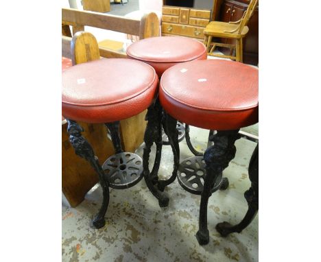 THREE CAST METAL CUSHION TOP BAR STOOLS