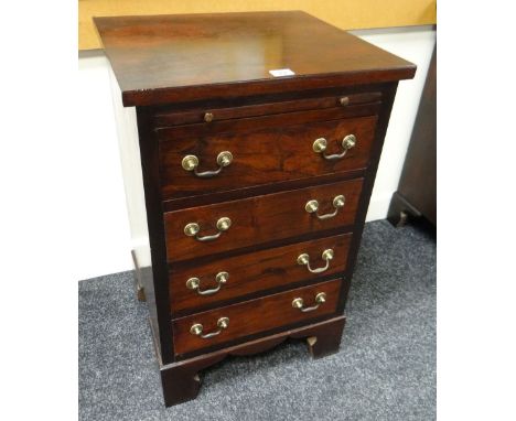 REPRODUCTION HARDWOOD SMALL CHEST having four drawers, brass handles, bracket feet and upper slide drawer, 45cms wide