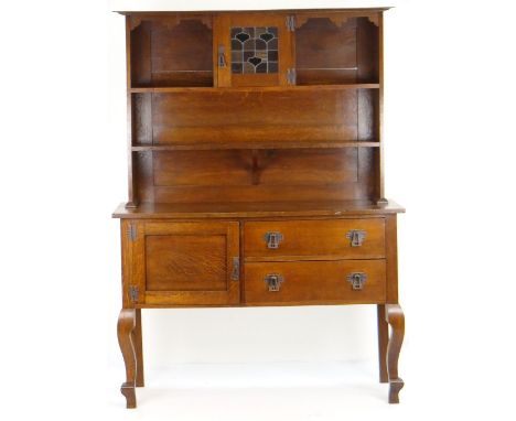 EARLY 20TH CENTURY OAK DRESSER having a base of two long drawers and single cupboard, three-shelf open rack with glazed centr