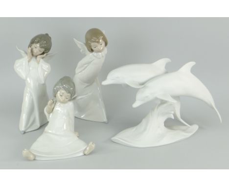 THREE LLADRO FIGURES OF ANGELS, together with a Lladro bisque style dolphin duo