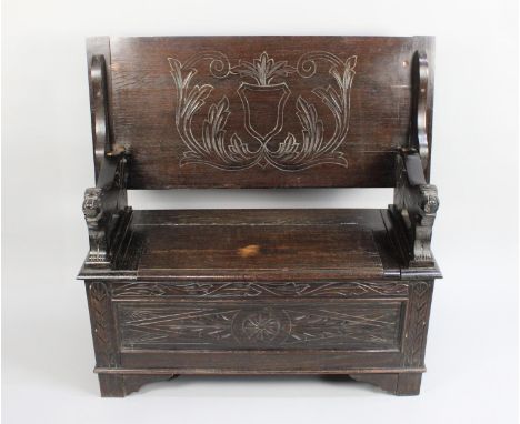 A Mid 20th Century Oak Monks Bench with Carved Lion Ends, 105cms Wide 