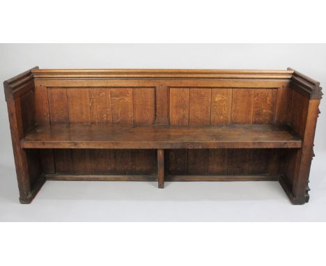 A Late Victorian Oak Pew with Gothic Carved End Panel and Rear Prayer Book Shelf, 181cms Long 