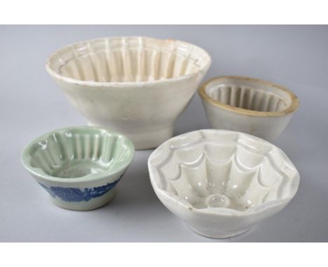 A Collection of Three Vintage and One Reproduction Jelly Moulds 