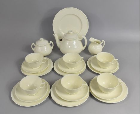 A Wedgwood Creamware Tea Set to comprise Six Cups, Six Saucers, Six Side Plates, Lidded Sugar Bowl, Cake Plate, Tea Pot and a