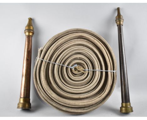 A Vintage Canvas Fire Hose Reel together with Two 19th Century Copper and Brass Fire Nozzles, Tallest 53cms High 