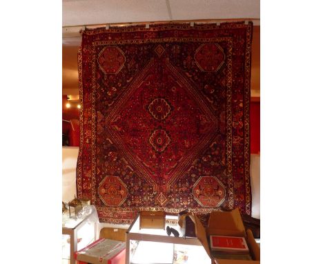 A fine north east Persian signed mashad carpet 385 x 270cm central double pendent medallion with repeating petal motifs on iv