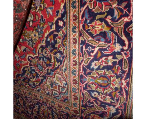 A fine central Persian Kashan carpet 293cm x 190cm central double pendent medallion on a rouge field within stylised floral s