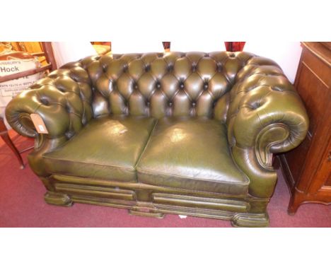 A two seater dell brook green leather Chesterfield sofa with button back and scrolling arms 