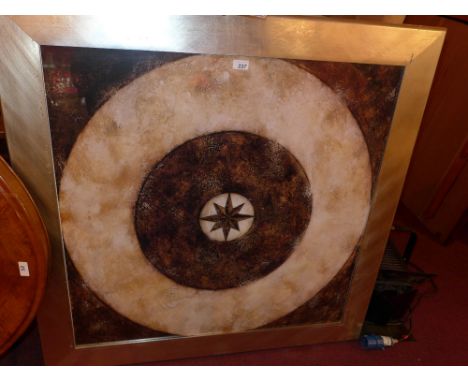 A contemporary print of a circular abstract design in a silvered frame 