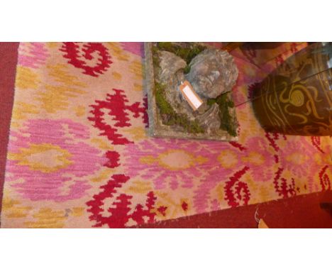 A contemporary wool carpet decorated with floral designs on an ivory field 