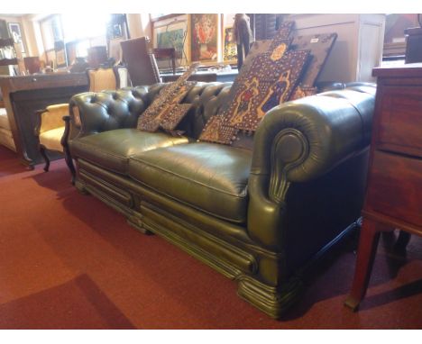 A three seater dell brook green leather Chesterfield sofa with button back and scrolling arms 