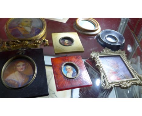 A collection of printed portrait miniatures in various frames 