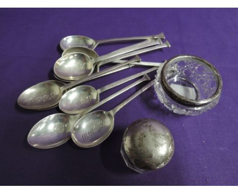 Ten matched HM silver coffee spoons having architectural knops and monogrammed bowls and two glass pots with HM silver collar
