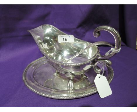 A silver plated sauce boat with saucer and ladle, all of traditional form, Viners Ltd, in original box retailed by Reids of N