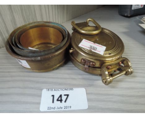 A brass compass and collapsible drinking vessel