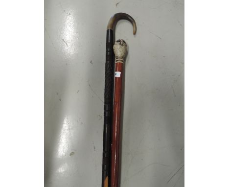 A walking stick and similar owl topped cane