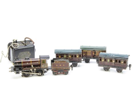 An early Märklin 0 Gauge 20 volt LMS 0-4-0 Locomotive Tender and Coaches, all in LMS maroon, the loco with '20 volt A' plaque