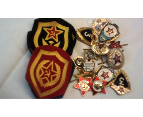 Soviet era military badges including: Officers cap badges and collar badges, Pilots proficiency badge, One and Three years go