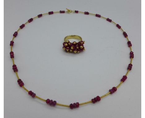 A 14ct gold and ruby necklet and matching yellow metal ring, size J