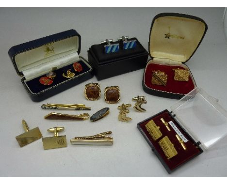 A collection of cufflinks and tie pins