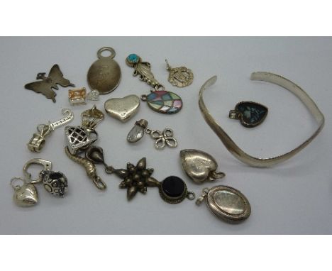 A silver bangle and twenty silver pendant/charms