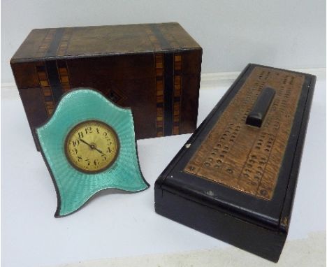 An inlaid caddy, a cribbage games box with cribbage board top, playing cards and an enamel clock