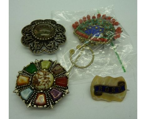 A white metal mounted, enamel and coral brooch, a filigree, enamel and coral brooch, two Scottish style brooches and a mother