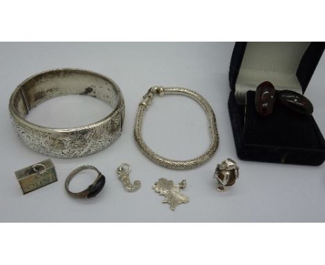 A silver bangle, a bracelet, a ring, charms and a pair of cufflinks